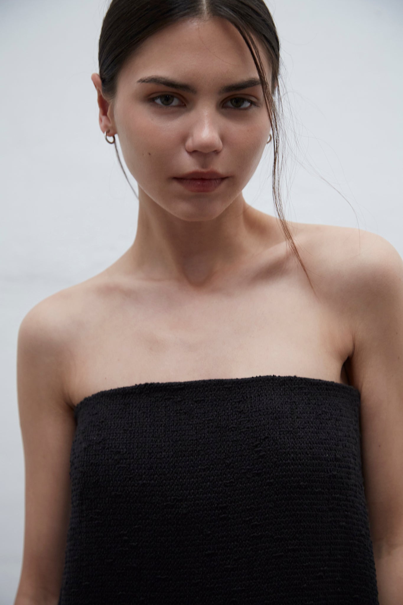 Bardot black strapless tweed dress with internal bustier and silicone bands for support, handmade in Barcelona