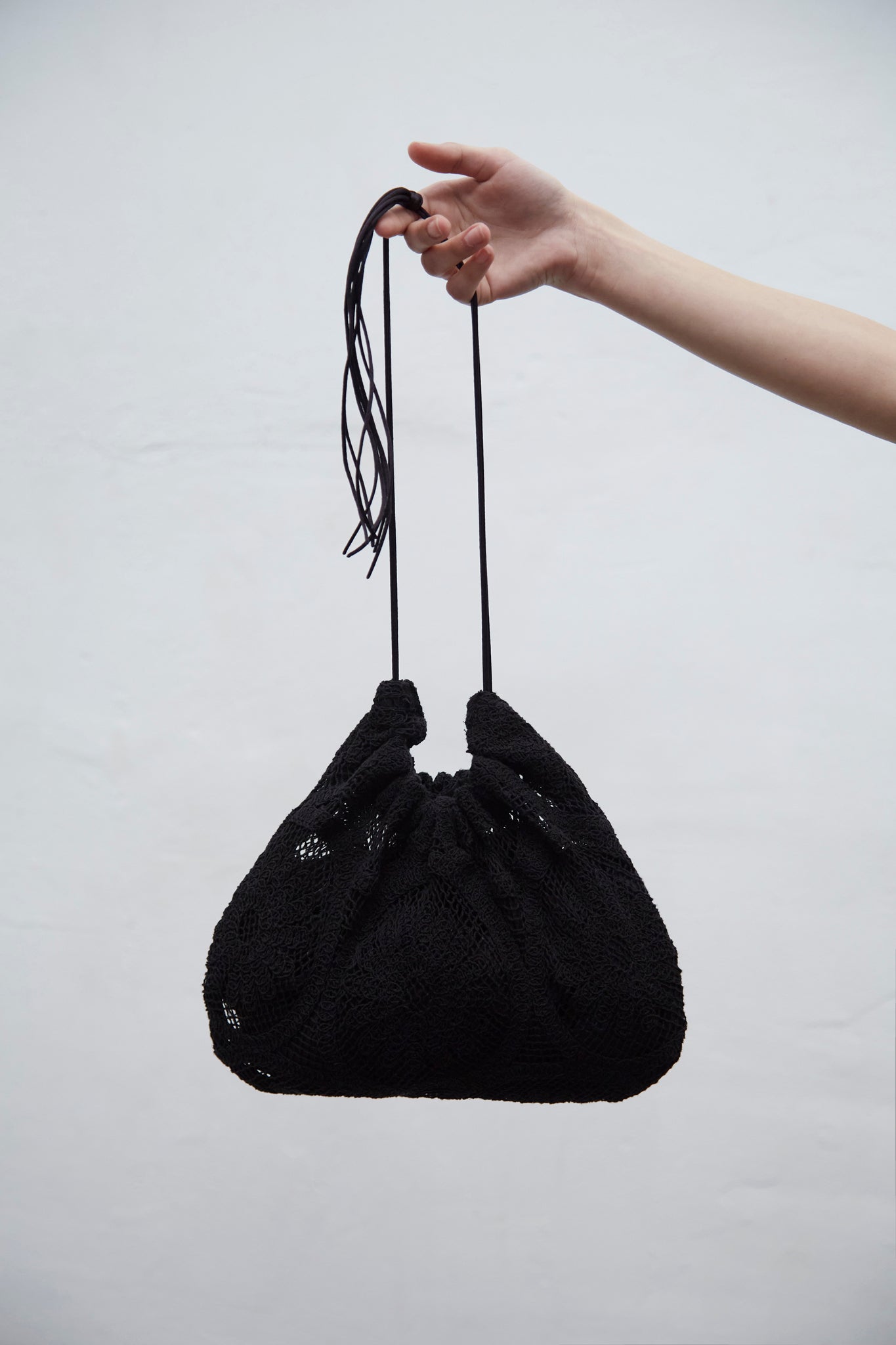 Clau black guipure crochet bag with gathered silhouette and cotton ties, handmade in Barcelona