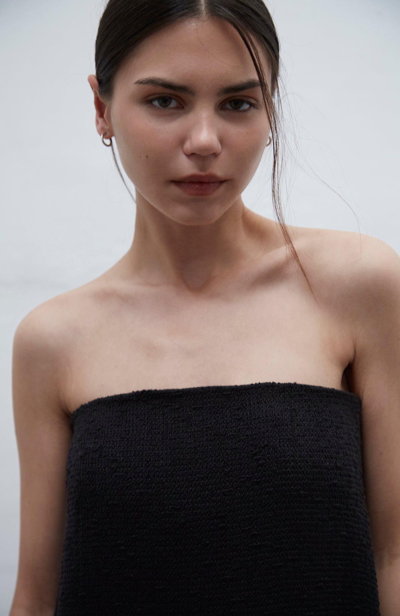 Bardot black strapless tweed dress with internal bustier and silicone bands for support, handmade in Barcelona